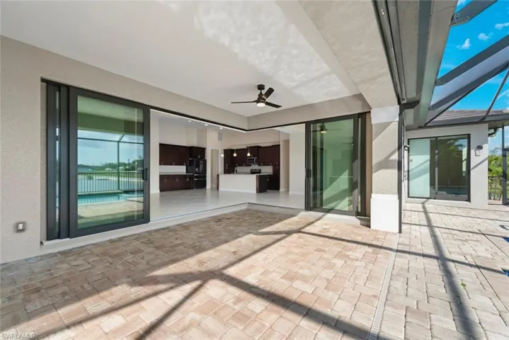 View of patio / terrace featuring ceiling fan and glass enclosure