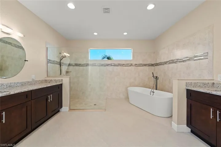 Bathroom featuring vanity and plus walk in shower