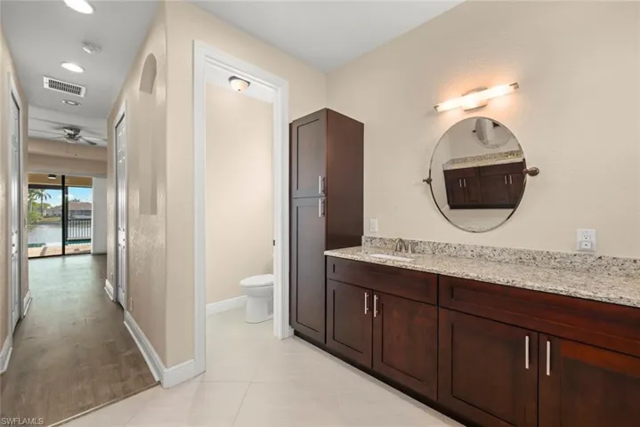 Bathroom featuring vanity, tile patterned floors, and toilet