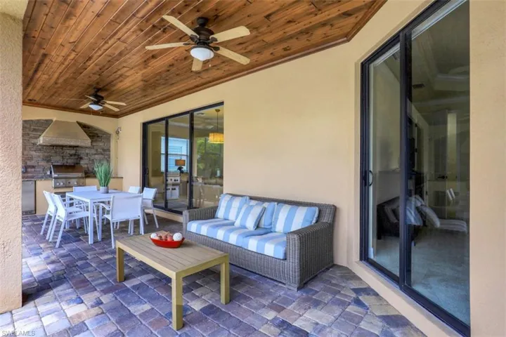 View of patio / terrace featuring outdoor dining space, ceiling fan, exterior kitchen, and outdoor lounge area