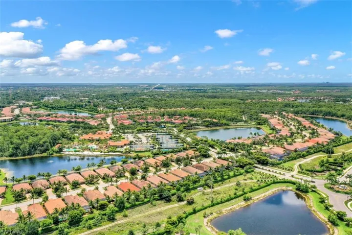 Aerial view of residential area featuring a nearby body of water