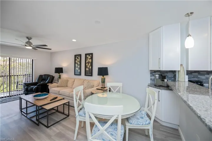 Living room featuring light wood-style flooring, recessed lighting, and ceiling fan