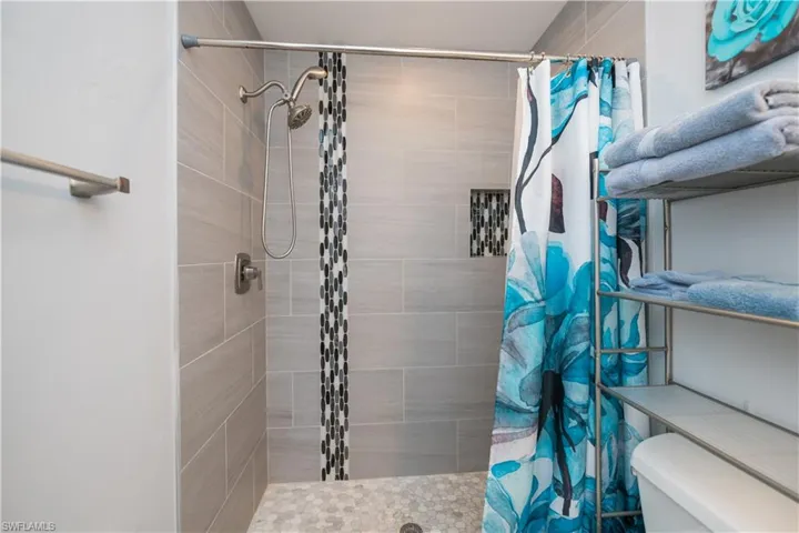 Bathroom with a stall shower and toilet