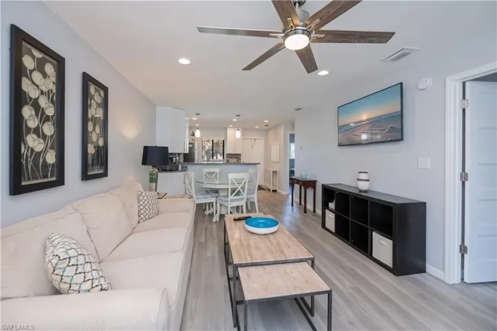 Living room featuring recessed lighting, light wood finished floors, and a ceiling fan