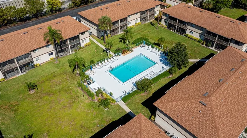 Aerial view of apartment complex / building and a pool area