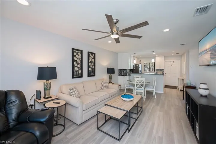 Living area featuring light wood-style flooring, recessed lighting, and a ceiling fan