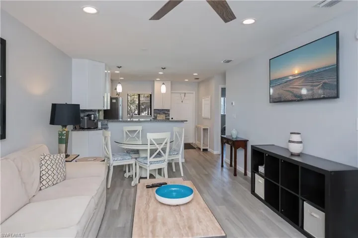 Living room with light wood finished floors, recessed lighting, and a ceiling fan