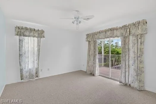 Guest bedroom #1 with  sliders to  balcony and preserve view