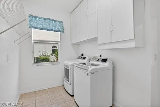 Large laundry room with newer washer/dryer, cabinets