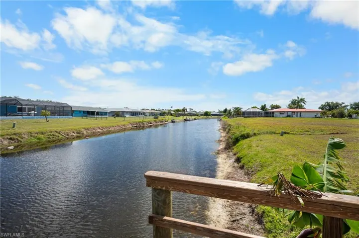 Waterfront canal frontage with a wooden dock or railing feature