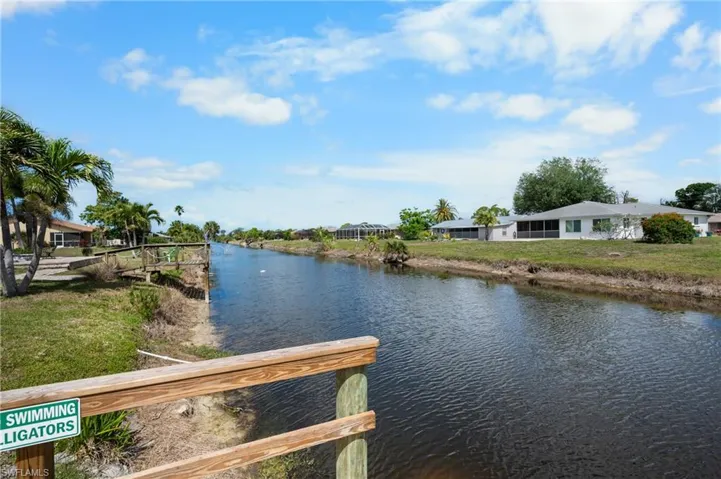 Canal-front property featuring direct water access and a wooden dock