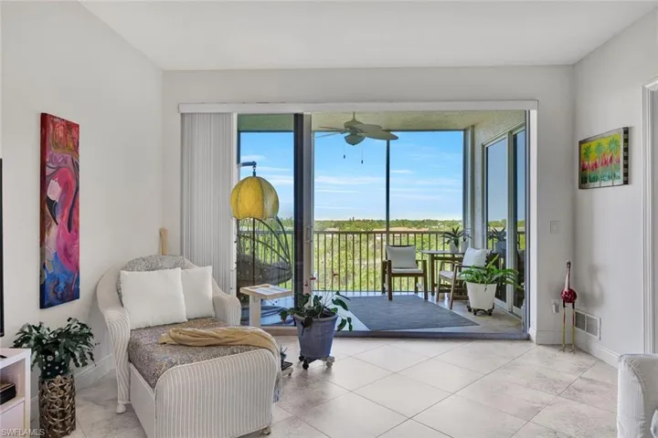 Expansive screened balcony with a ceiling fan
