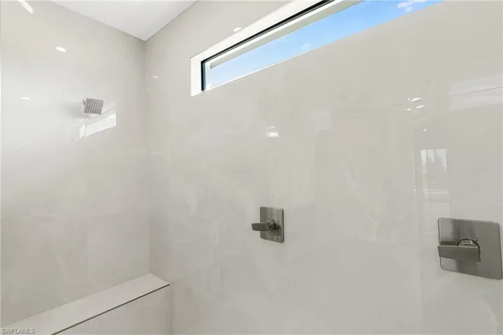 Full bath featuring tiled shower