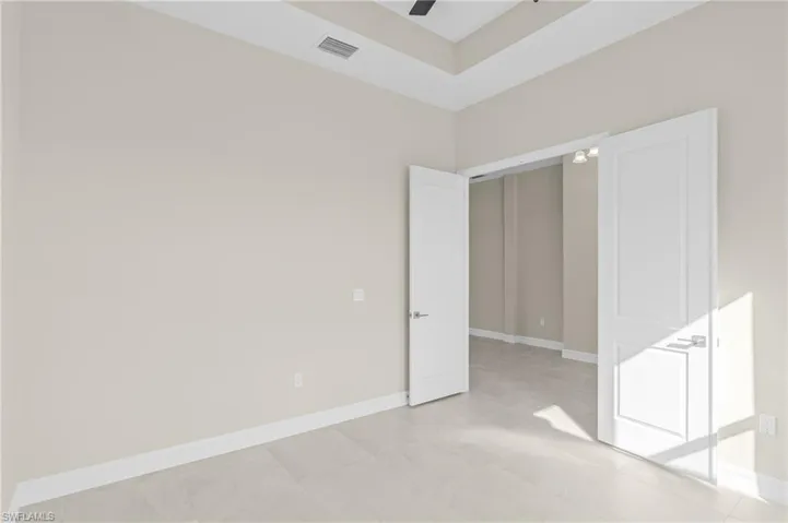 Unfurnished bedroom with baseboards and ceiling fan