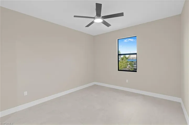 Empty room with baseboards and ceiling fan