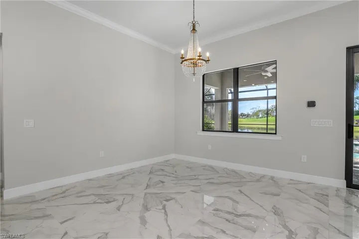 Casual dining space, or perfect for a side bar or conversation set, located just off the sliders and provides views of the outdoor living space and pond.
