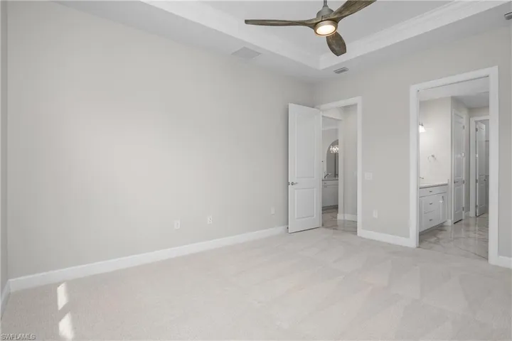 Owner suite features spa-like bath, walk-in closet, tray ceilings with crown molding.