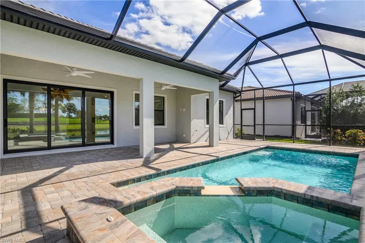 Outdoor screened lanai includes spacious under cover area, inground heated pool and spa, overhead ceiling fans and a great water view.