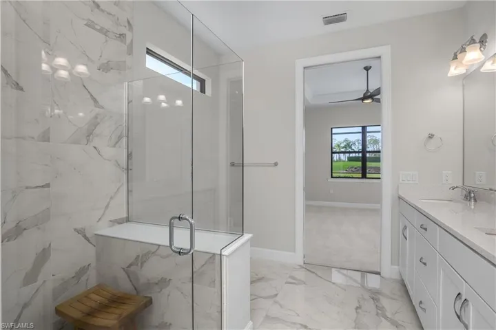 Primary bathroom is the perfect retreat, with glass enclosed walk in shower, dual sinks, and lots of natural light.