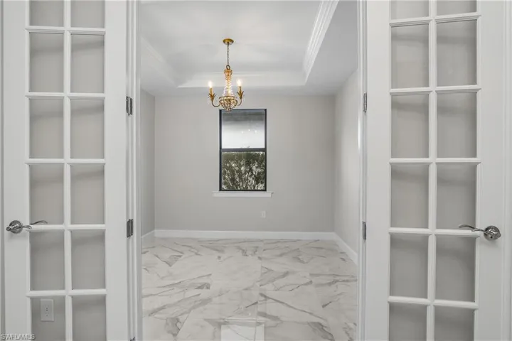 Dedicated Den/Office features double french door entry, tray ceiling, and crown molding.