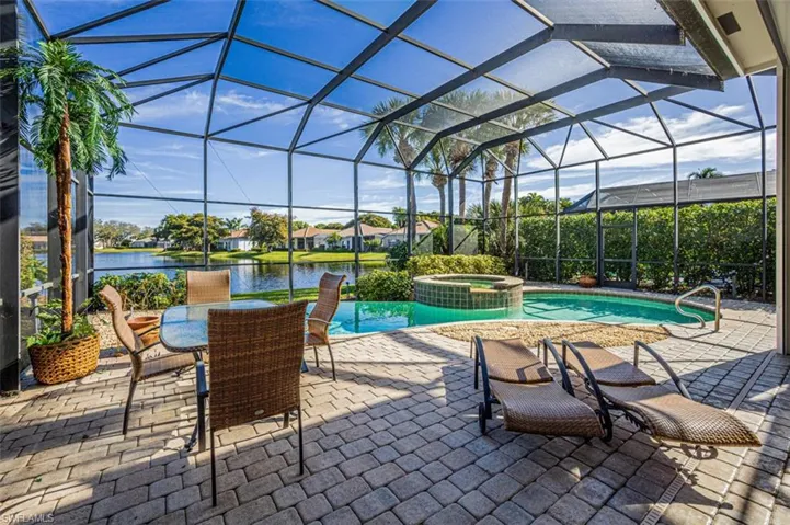 Enjoy your heated pool/spa with the beautiful lake view w/ lush greenery