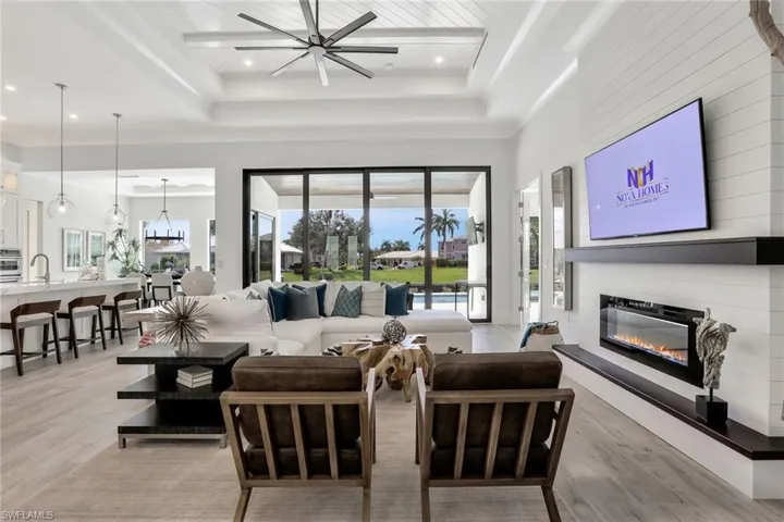 Living room featuring light hardwood / wood-style floors, plenty of natural light, and a raised ceiling