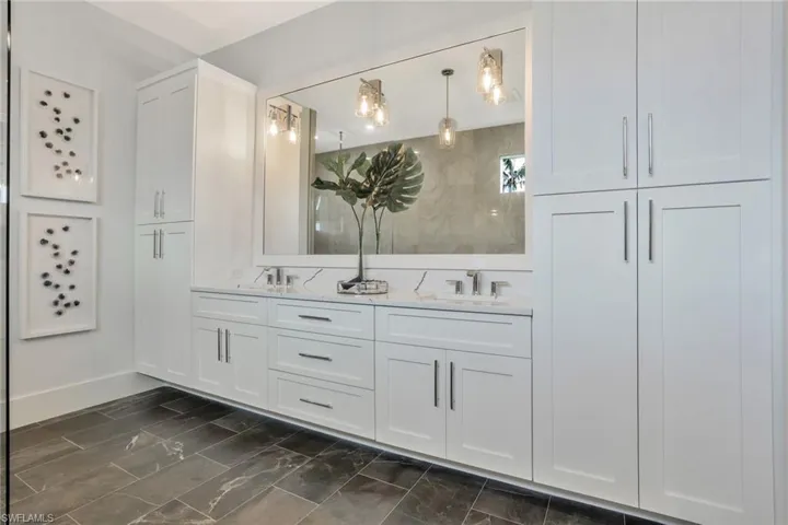 Bathroom with tile patterned flooring and dual bowl vanity