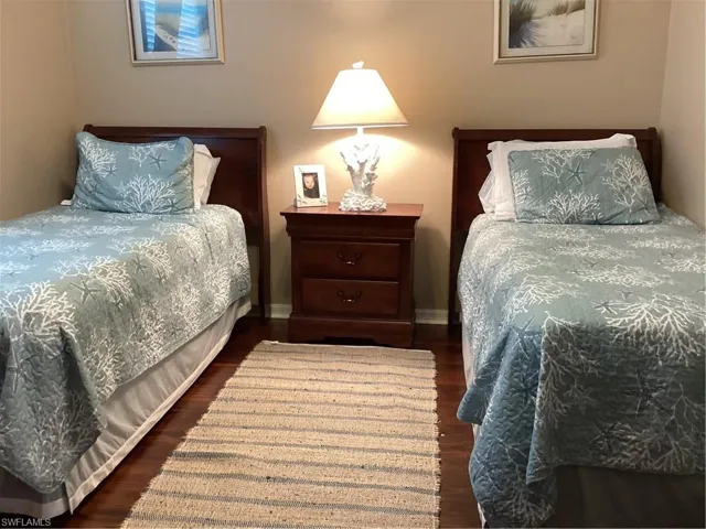 Bedroom with dark wood-type flooring