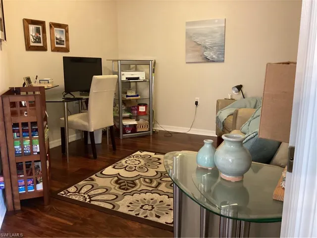 Home office featuring dark wood-type flooring