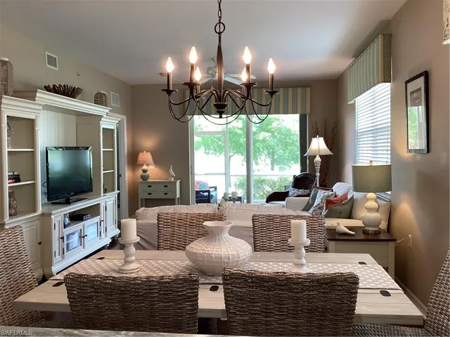 Living room with wood-type flooring and a chandelier