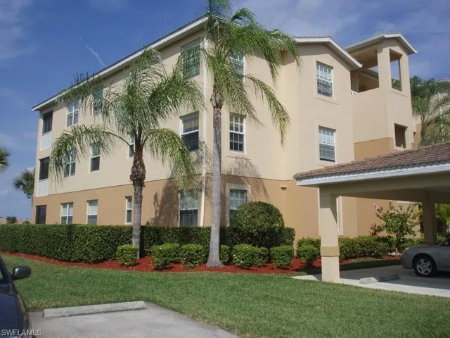 View of building exterior featuring a carport