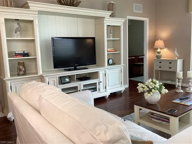 Living room with dark hardwood / wood-style flooring