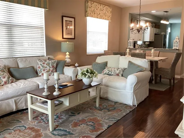 Living room with dark hardwood / wood-style floors, a chandelier, and sink