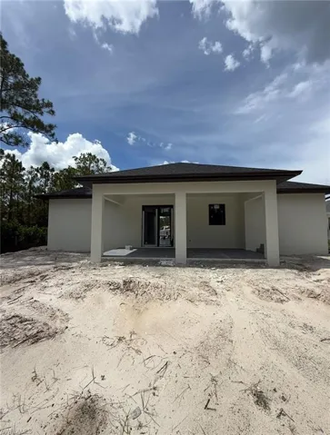 Back of property with stucco siding