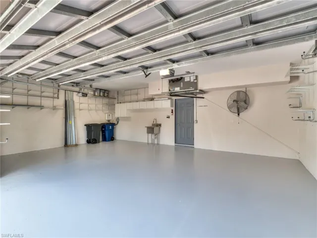 SPACIOUS 3-CAR GARAGE WITH AMPLE STORAGE AND NEW EPOXY FINISH