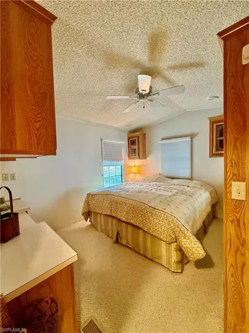 Bedroom featuring light carpet and ceiling fan