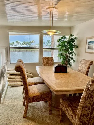 Dining room with carpet flooring and a water view