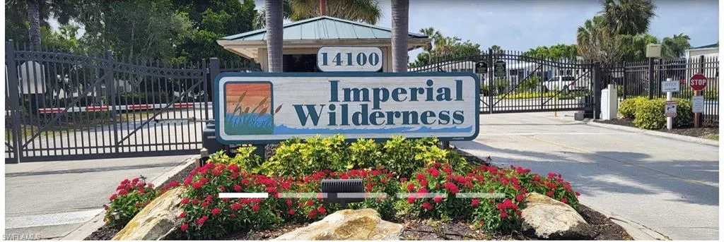 Community / neighborhood sign featuring a gate