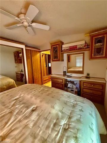 Bedroom featuring a textured ceiling and a ceiling fan