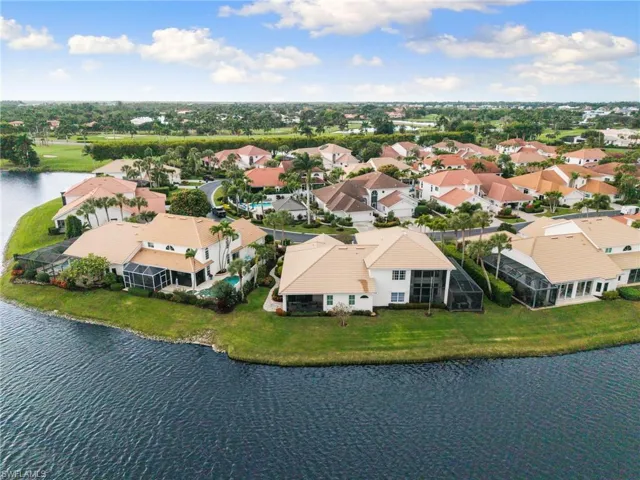 Aerial perspective of suburban area with a nearby body of water
