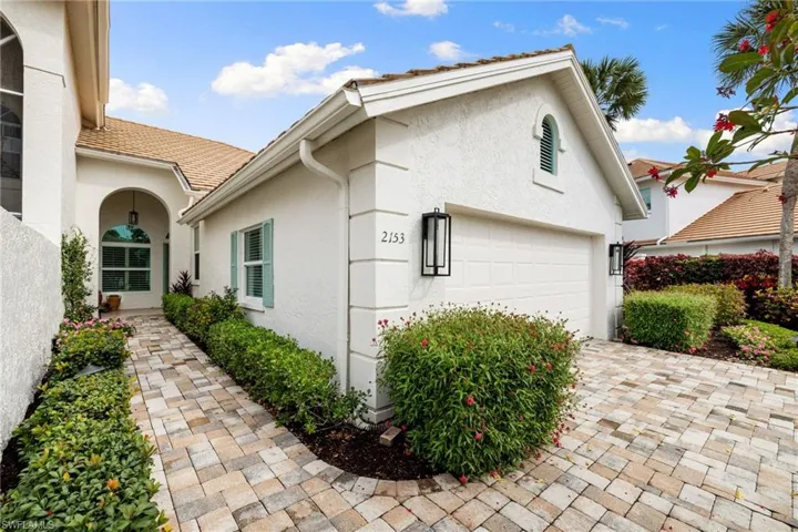 View of side of home featuring stucco siding and driveway
