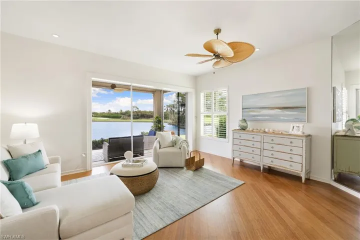 Living area featuring light wood-style flooring, a water view, ceiling fan, and recessed lighting