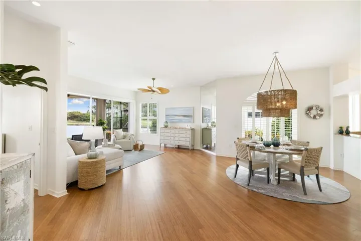 Living room featuring light wood-type flooring, plenty of natural light, and a ceiling fan