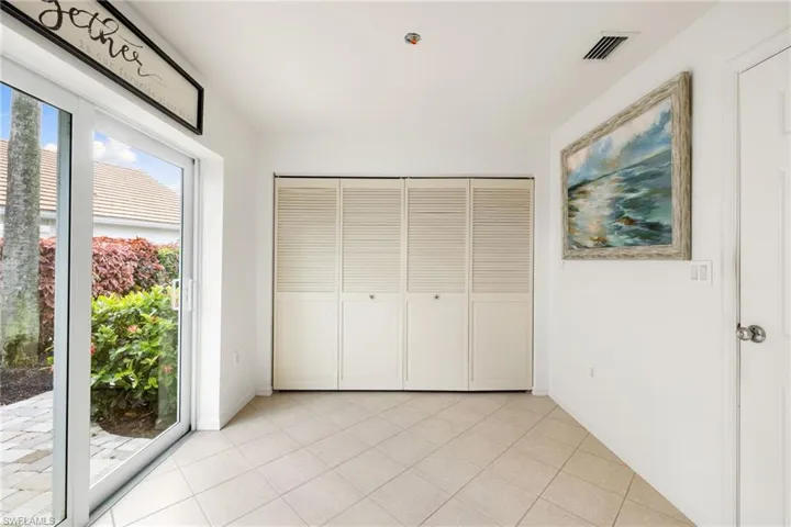 Unfurnished bedroom with a closet, light tile patterned floors, and access to outside