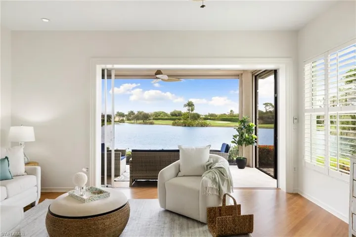 Living area with wood finished floors, a water view, and healthy amount of natural light