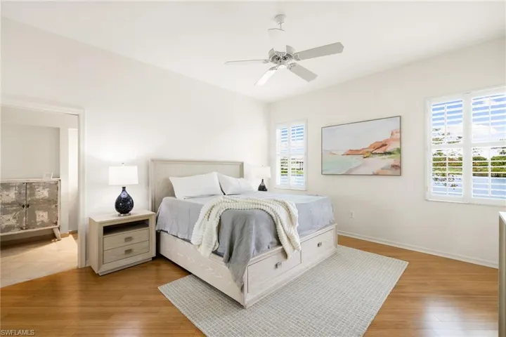 Bedroom with ceiling fan and light wood finished floors