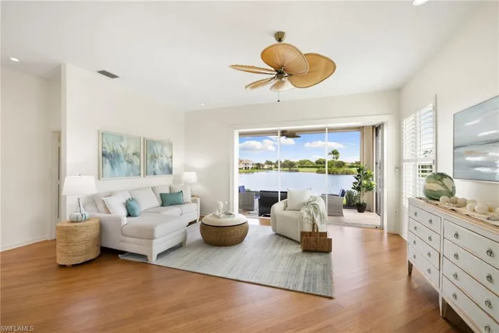 Living room with light wood finished floors, healthy amount of natural light, recessed lighting, and ceiling fan