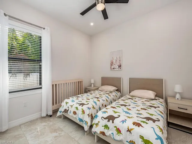 Bedroom with a ceiling fan and recessed lighting