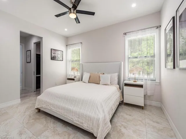 Bedroom featuring a ceiling fan, recessed lighting, and connected bathroom
