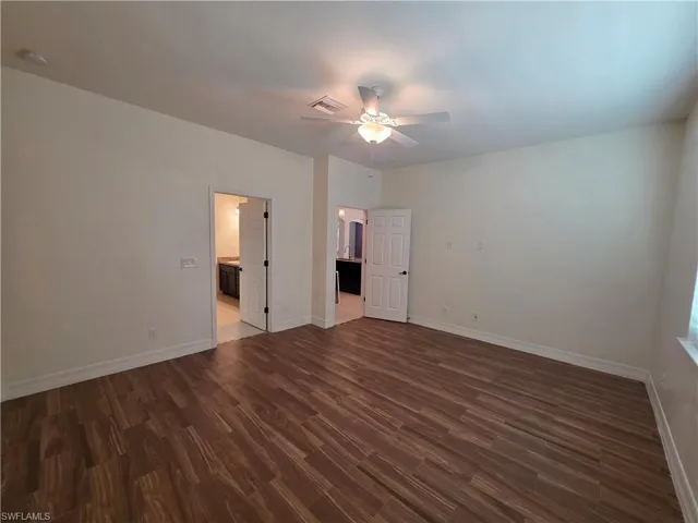 Wood-finish tile flooring throughout, ceiling fan with integrated lighting, and two interior doors